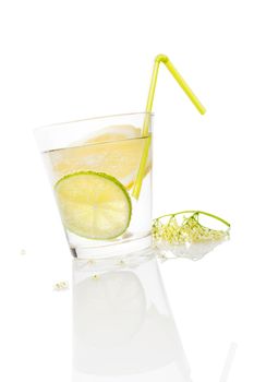 Healthy homemade organic elderberry lemonade with lime slices isolated on white background. Refreshing seasonal nonalcoholic summer drink.