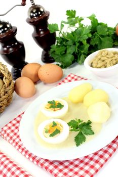 Mustard eggs with potatoes on a light background