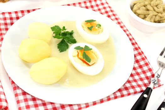 boiled eggs with mustard potatoes on a light background