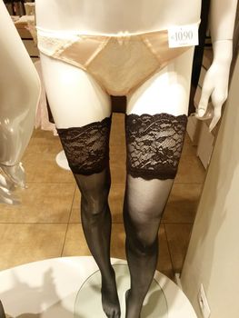 MILAN, ITALY - circa November 2014 - Yamamay black holdups with luxurious lace top band worn by a mannequin in a shop window