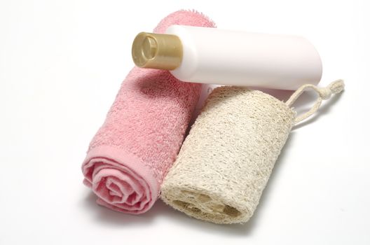 liquid soap loofah and pink towel isolated on a white background