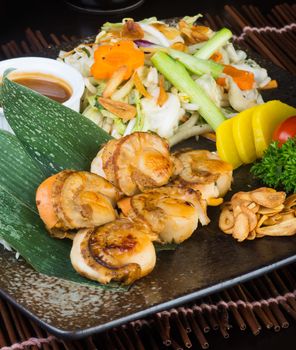 japanese cuisine. grilled shell fish on background