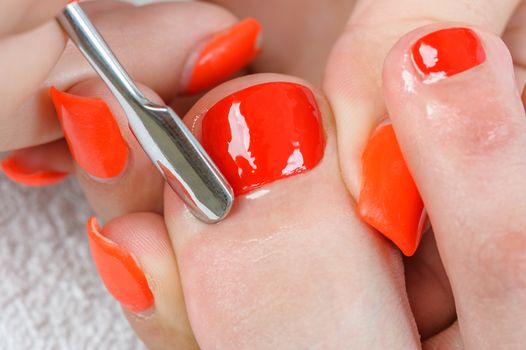 pedicure process with cuticle on toe, macro closeup