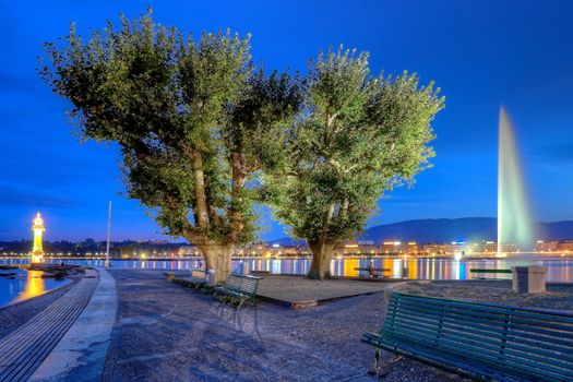 Famous Geneva fountain, lighthouse at the bains des Paquis and lake by night, Switzerland, HDR