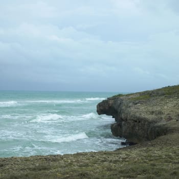 Edge of a cliff with turquoise ocean