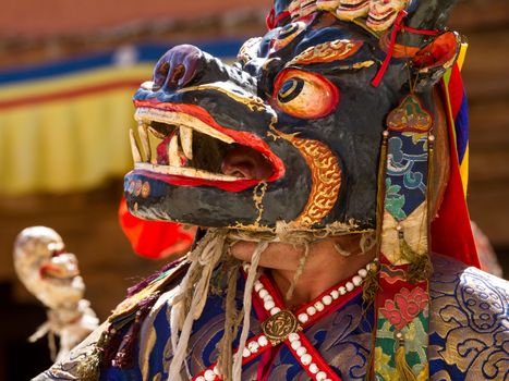 KARSHA, INDIA - JUL 17: unidentified monk performs a religious mask dance during the Cham Dance Festival on Jul 17, 2012 in Karsha, India.