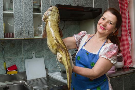 woman on kitchen with the big fish