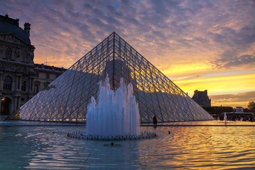 PARIS - OCTOBER 10: The Louvre Pyramid on October 10, 2014 in Paris, France. It serves as the main entrance to the Louvre Museum. Completed in 1989 it has become a landmark of Paris.