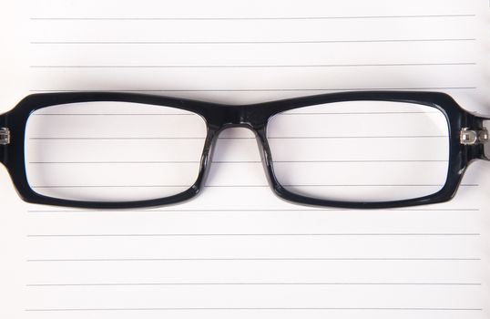 eye glasses. eye glasses with book on background