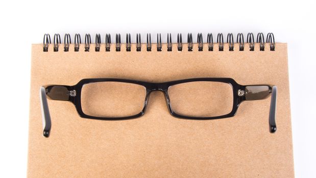 eye glasses. eye glasses with book on background