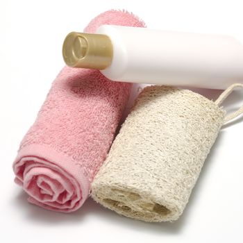 liquid soap loofah and pink towel isolated on a white background