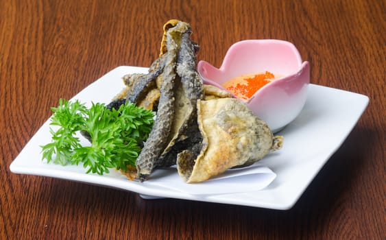 japanese cuisine. fried fish skin on background