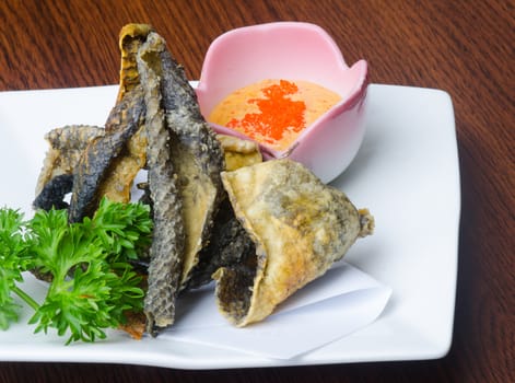 japanese cuisine. fried fish skin on background