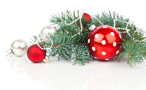 Christmas balls and fir branches with decorations isolated over white