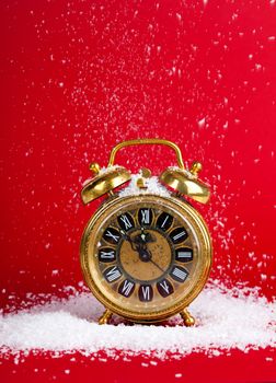 vintage christmas decoration goldenantique golden clock in snow on red background