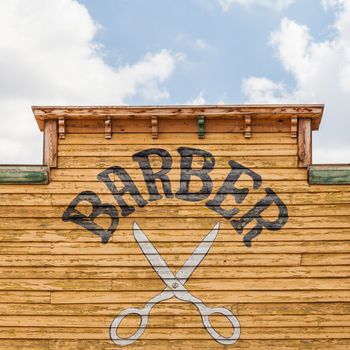 Old barber sign on an abandoned building
