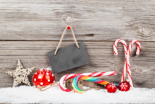 Christmas decoration with xmas canes, over wooden background