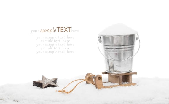 Snow in a bucket on a sled, isolated over white background, with copyspace for your greeting