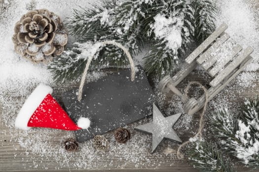 Christmas decoration over snow, wooden background