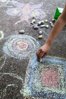 Chalk drawing hand outside on asphalt, woman hand..