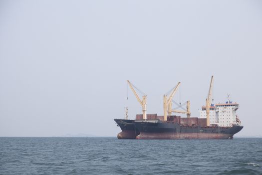 Large cargo ship Boats moored in the sea to make sense compared to the coast.