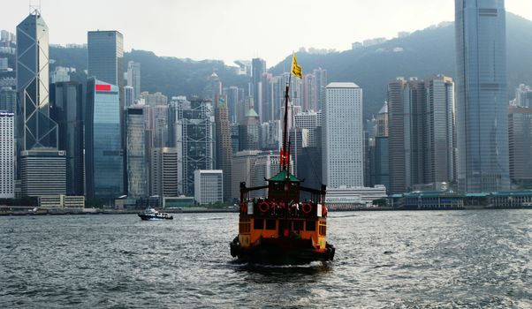 Ship in front of another beach of the river, skyscrapers, Hong Kong