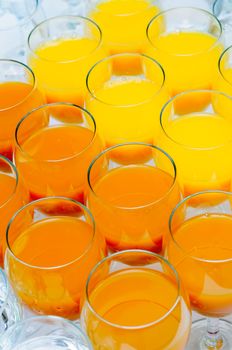 many glasses of juice and water on buffet table