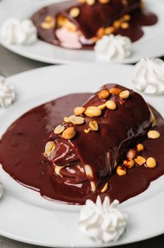 chocolate crepes on plate, decorated with cream, selective focus