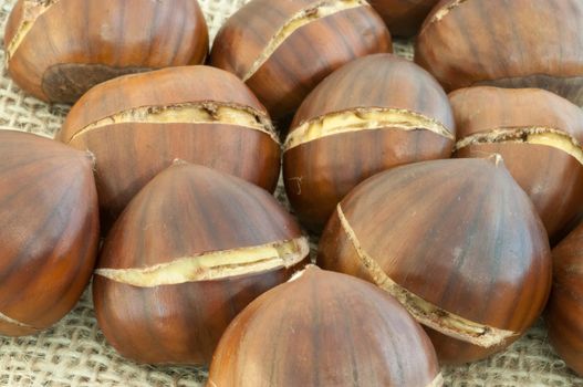 raw natural macro of chestnuts in jute background