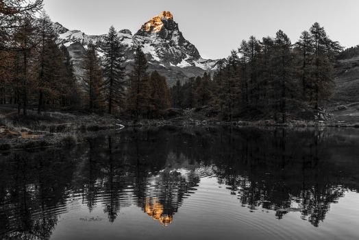 The top of the Matterhorn lit by the sun at sunset, Aosta Valley