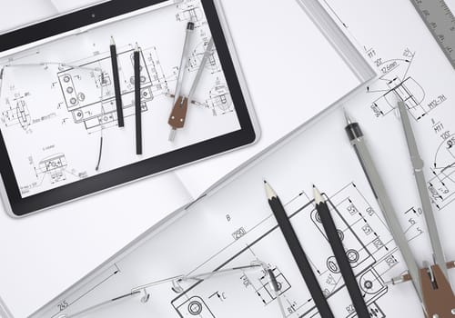 Tablet pc lying on open enpty book and engineering drawings. Tools are close by. Industrial concept