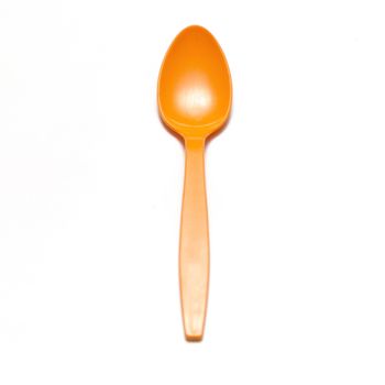 orange plastic spoon on a white background