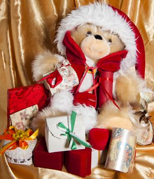 a doll with hat of santa claus and gifts