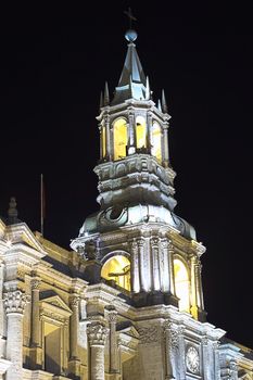 The steeple of the Basilica Cathedral on Plaza de Armas in Arequipa in Southern Peru photographed at night. The historic city center of Arequipa is an UNESCO World Cultural Heritage Site. 