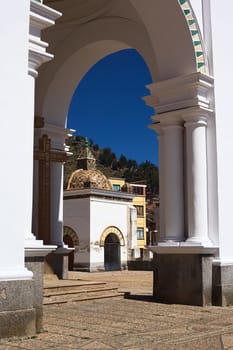 View through archway onto a small chapel on the courtyard of the Basilica of Our Lady of Copacabana in the small tourist town of Copacabana along Lake Titicaca in Bolivia