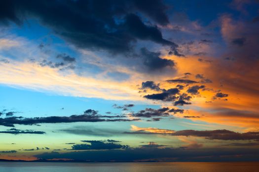 Evening sky with colorfully lit clouds shortly after sunset over Lake Titicaca viewed from the small tourist town of Copacabana in Bolivia 
