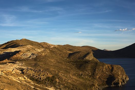 The Northern part of Isla del Sol (Island of the Sun), a popular tourist destination on Lake Titicaca, Bolivia before sunset. In the left lower corner the Tiwanaku-Inca ruin Chinkana is visible.