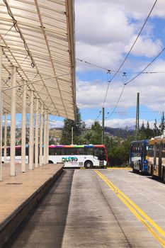 QUITO, ECUADOR - AUGUST 8, 2014: An empty local bus with Quito Alcaldia sign on it standing outside the Terminal Terrestre Quitumbe (long-distance bus terminal) on August 8, 2014 in Quito, Ecuador  
