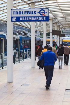 QUITO, ECUADOR - AUGUST 8, 2014: Unidentified people walking at the Trolebus (trolleybus) disembark area of the local public transportation system at the Terminal Terrestre Quitumbe (long-distance bus terminal) on August 8, 2014 in Quito, Ecuador