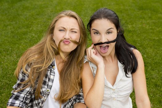 Outdoor portrait of a happy teenagers making funny faces