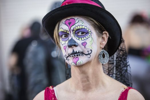 Serious female in hat with makeup for Dia De Los Muertos