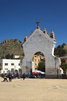 COPACABANA, BOLIVIA - OCTOBER 18, 2014: The gate of the Basilica of Our Lady of Copacabana seen from the courtyard of the church with view of the Mount Calvario in the back on October 18, 2014 in Copacabana, Bolivia 