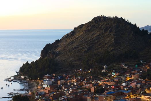 COPACABANA, BOLIVIA - OCTOBER 24, 2014: View shortly after sunset over the small touristy town of Copacabana and Lake Titicaca photographed from Kesanani hill on October 24, 2014 in Copacabana, Bolivia