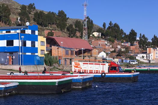TIQUINA, BOLIVIA - OCTOBER 16, 2014: Truck on wooden ferry waiting to be transported over the Strait of Tiquina at Lake Titicaca on October 16, 2014 in San Pablo de Tiquina, Bolivia