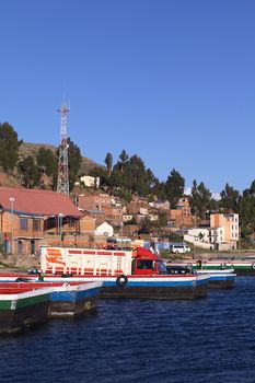 TIQUINA, BOLIVIA - OCTOBER 16, 2014: Truck on wooden ferry waiting to be transported over the Strait of Tiquina at Lake Titicaca on October 16, 2014 in San Pablo de Tiquina, Bolivia