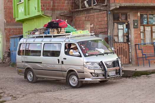 TIQUINA, BOLIVIA - OCTOBER 16, 2014: Unidentified people sitting in a minibus going to Copacabana on October 16, 2014 in San Pedro de Tiquina, Bolivia. Such minibuses are used for local and short-distance transportation. 