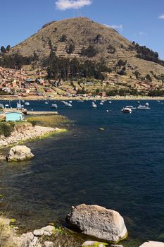 COPACABANA, BOLIVIA - OCTOBER 17, 2014: Motor boats anchoring in the bay of the small tourist town on the shore of Lake Titicaca on October 17, 2014 in Copacabana, Bolivia. Copacabana is the starting point for tours and transportation to Isla del Sol (Sun Island).