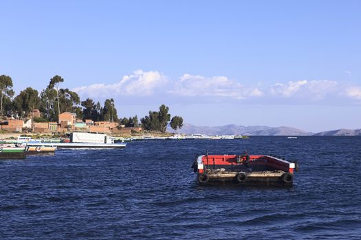 TIQUINA, BOLIVIA - OCTOBER 16, 2014: Empty wooden ferry on Lake Titicaca at the Strait of Tiquina on October 16, 2014 in San Pablo de Tiquina, Bolivia. Vehicles are being transported over on these wooden ferries, passengers and pedestrians have to use small motorboats to cross.
