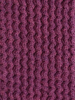 Purple cable knitting stitch as an abstract background texture