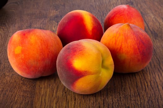Fresh peaches on a dark wood background